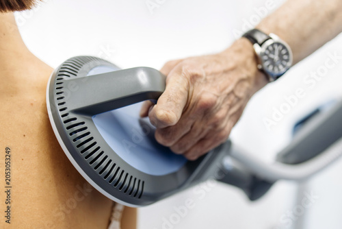 Фотография Female patient undergoing electromagnetic back therapy in advanced medical center
