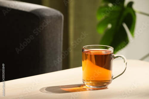 Glass cup of hot black tea ...