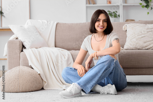 Smiling young woman sitting...
