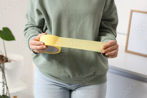 Young woman with masking ta...