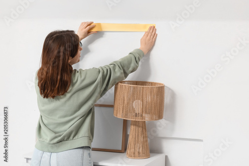 Young happy woman applying ...