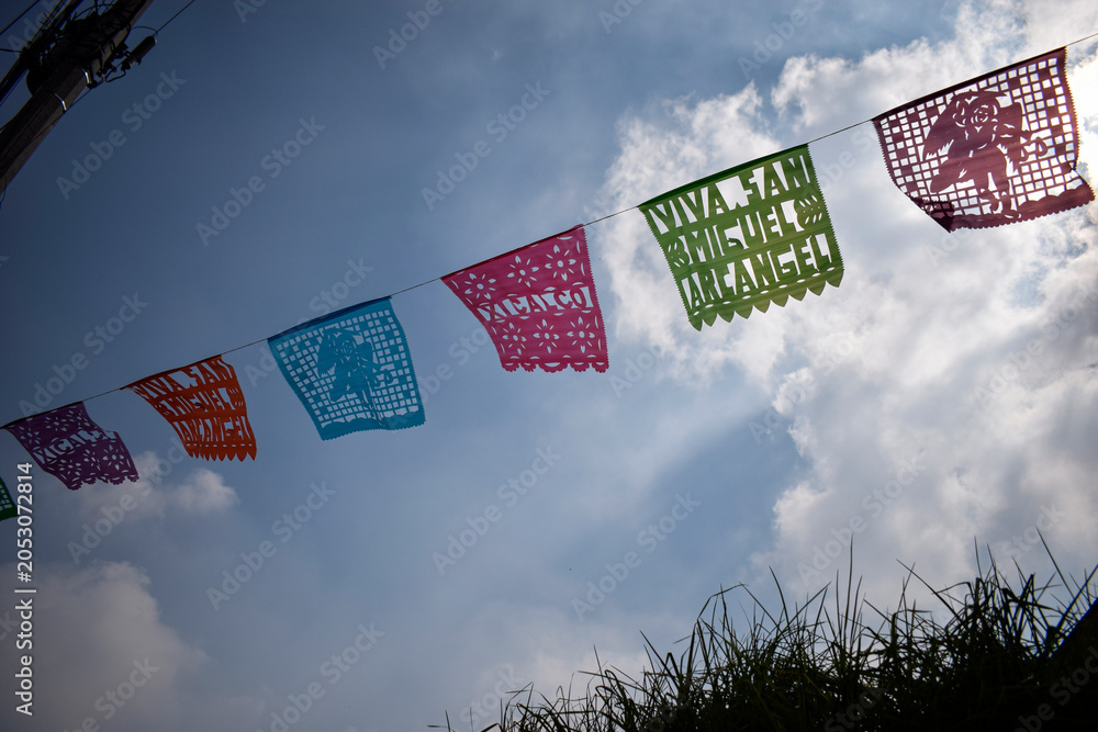 Fototapeta premium Colorful Papel Picado Banners Celebrating San Miguel Xicalco Tradition in Mexico