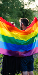 couple holding rainbow flag for pride month