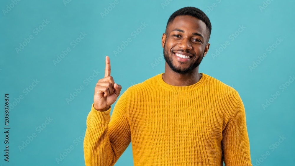 Fototapeta premium Smiling Man Pointing Up with Finger Isolated on Blue Background Presenting Copy Space for Advertisement