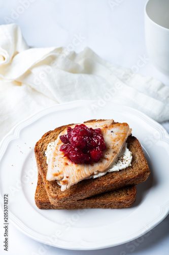Open Sandwich with leftover turkey slices with cranberry sauce on top. Perfect holiday breakfast or lunch