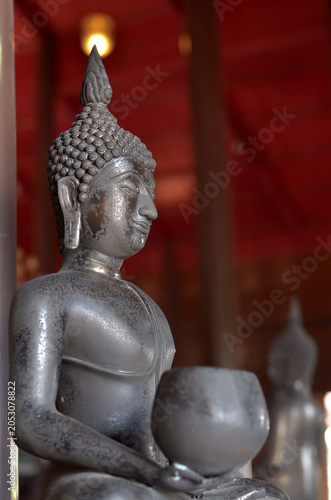 The buddha image in meditation while holding an alms bowl.