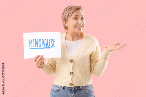 Mature woman holding paper ...