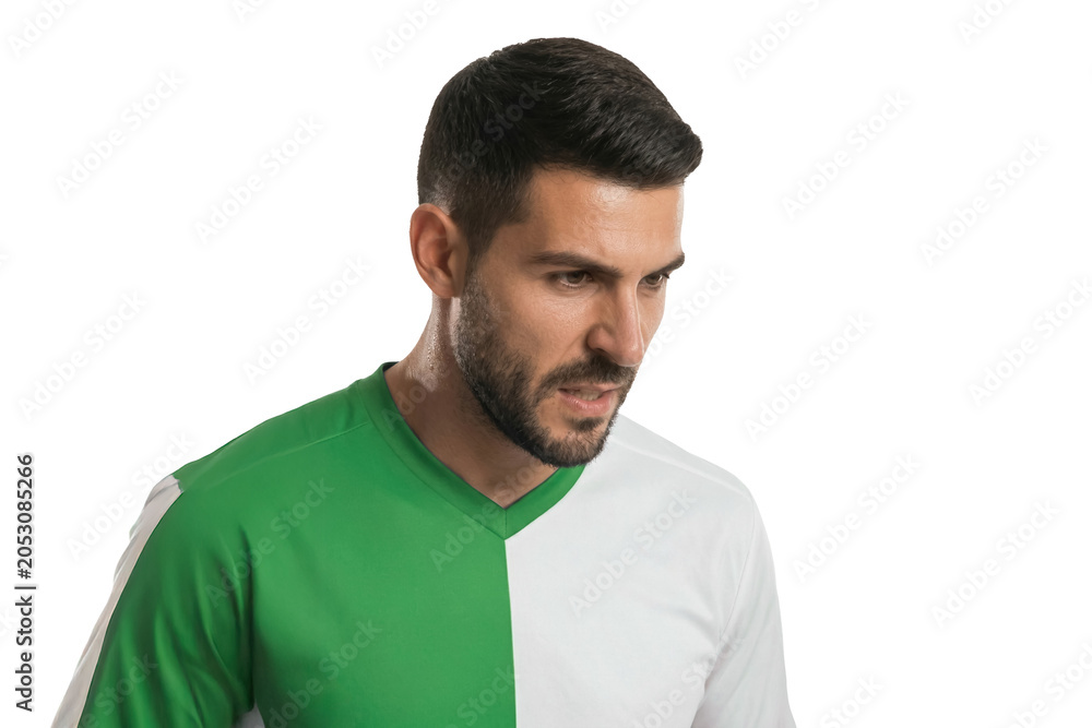 Fototapeta premium Headshot of a determined player in green soccer jersey