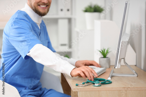 Male doctor working with co...