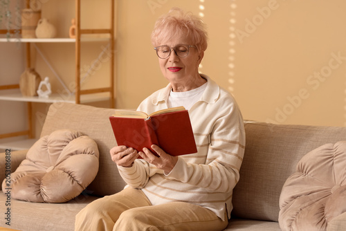 Happy senior woman reading ...