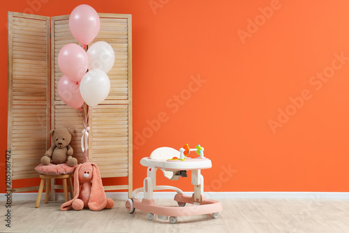 Baby walker with balloons a...