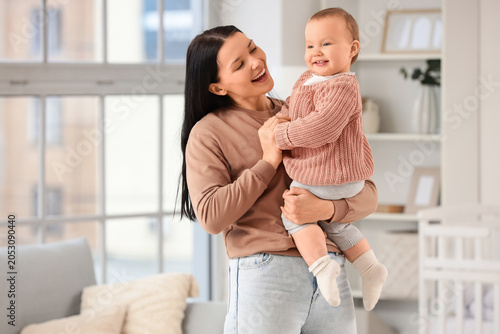 Young mother holding her li...