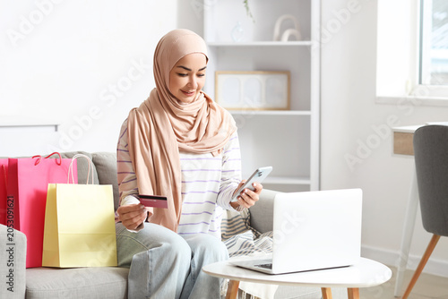 Muslim woman with mobile ph...