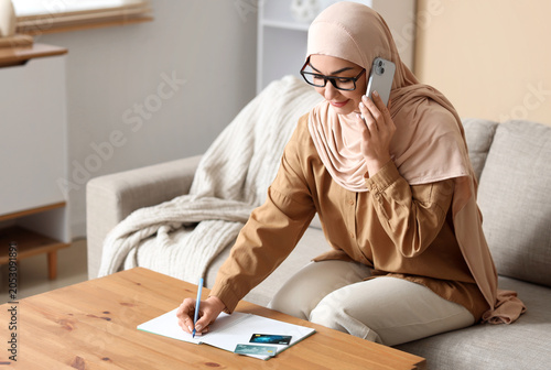Muslim woman with mobile ph...