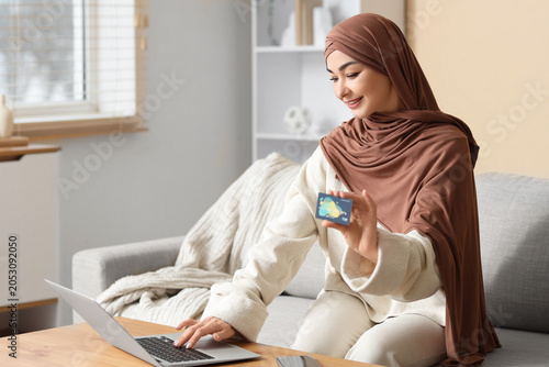 Muslim woman with credit ca...