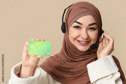 Muslim woman in headset wit...
