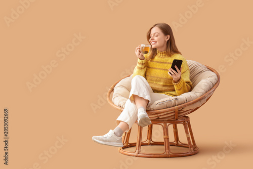 Young woman with glass cup ...