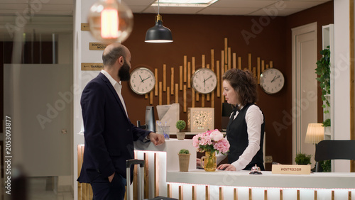 Slika na platnu Hotel personnel providing luxury services for entrepreneur in suit en route to a