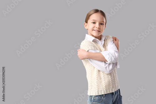 Cute girl hugging herself o...