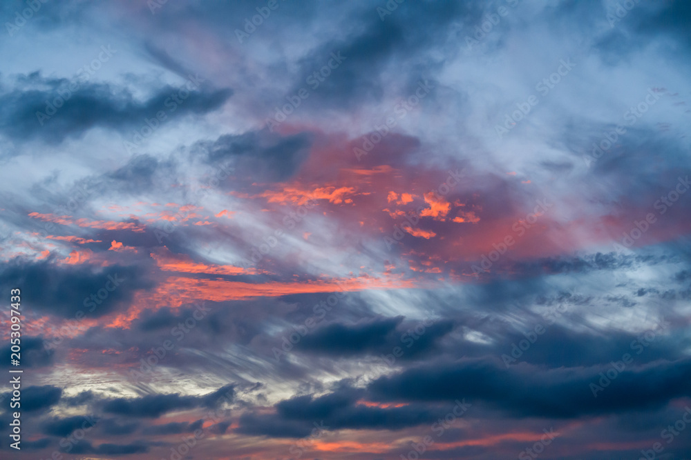 Fototapeta premium Colorful sunset clouds cover the wide evening sky over the dark Key West ocean horizon during the tropical summer season.