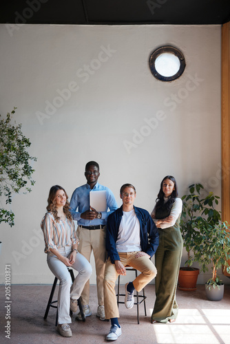 Diverse multi-ethnic creative team collaborating in a modern coworking office space, fostering unity and inclusion among professional colleagues