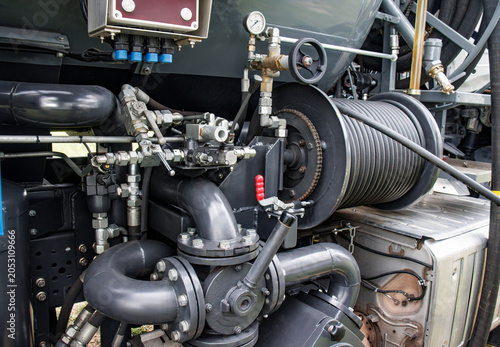 Industrial pump system with hydraulic hoses and reel