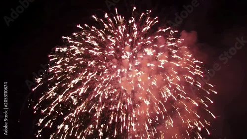 Exploding Fireworks Display at Night Sky, Bright Bursts and Trails of Light, Smoke Fading in Darkness, 4K