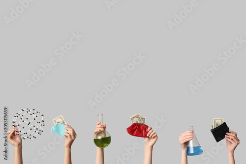 Photos Hands holding science equipment and money wallets, research funding and financia