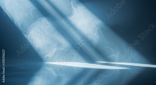 Abstract blue light rays and bokeh on dark background.