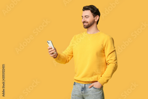 Young man with modern mobil...