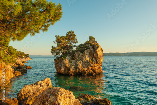 Famous Kamen Brela (Brela Rock) islet off the coast of Punta Rata Beach surrounded by clear turquoise Adriatic Sea, in Brela town on the Makarska Riviera in Croatia
