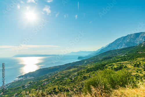Panoramic view of the Podgora town and Makarska Riviera on the Dalmatian coast of Adriatic Sea from the pine-covered slopes of Biokovo Mountains, Croatia