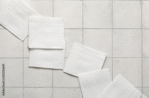 Paper napkins on white tile...