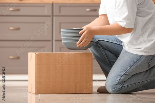 Young woman with clean dish...