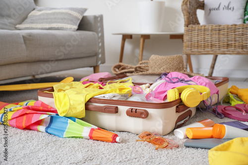 Open suitcase with summer a...