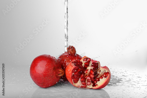 Fresh pomegranates with wat...
