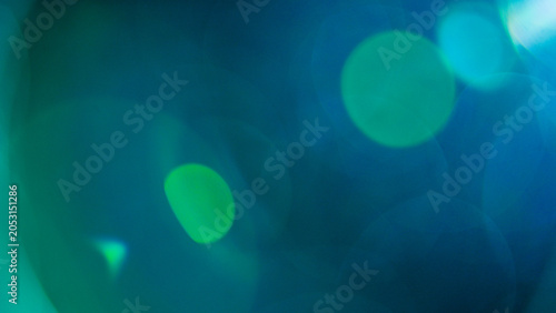 Billede på lærred Abstract background with distinct teal-colored light flares and circular bokeh, creating a sense of depth and digital sophistication for technological themes