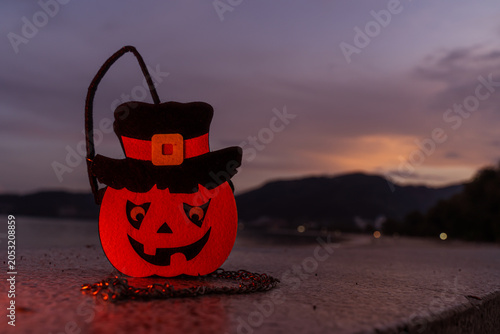 Concept: Halloween beach and ocean background with pumpkins, witches, ghosts, dark, scary tones.