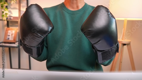 Konstfotografi Wearing boxing gloves, this person poses strong and confident, showing mental toughness at work