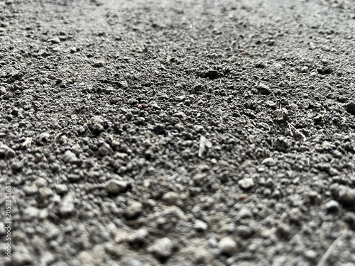Selective Focus Macro Dirt and Soil Surface Texture. Low angle view of granular soil background with selective focus. Selective focus of field soil.