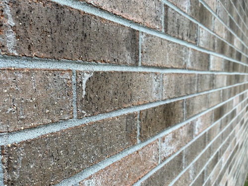 Brown and Orange Brick Wall Texture with Industrial Perspective. Rustic architectural brickwork pattern with linear perspective. Close up of textured brown bricks with shallow depth of field.