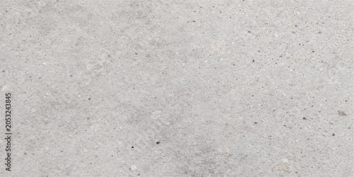 Foto A close-up, high-angle view of a concrete surface reveals its textured and grainy composition, highlighting subtle variations in tone and aggregate distribution