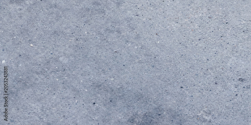 Fotografija A close-up texture of weathered concrete, showing its rough, granular surface with subtle variations in tone and shadow