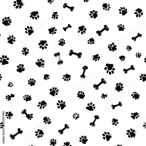 Seamless pattern with black dog paw prints and bones on a white background, featuring a grunge texture