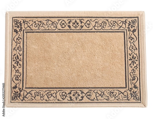 Rectangular tan-colored floor mat with a dark decorative border. The center is lighter with a textured surface