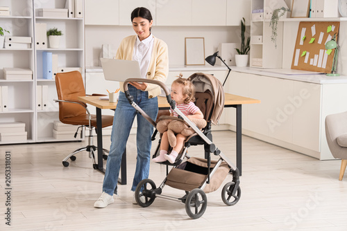 Working mother with laptop ...