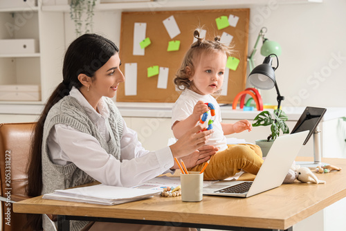 Young mother working remote...