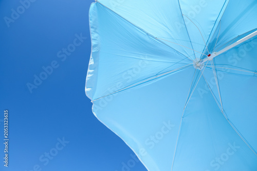 Bright blue beach umbrella ...