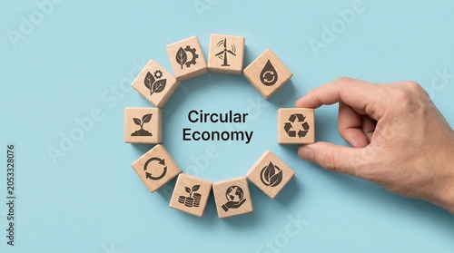 Circular Economy concept illustrated with wooden blocks featuring environmental icons and text on a light blue background