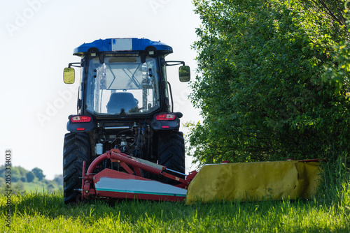Foto The tractor cuts the grass on the meadow